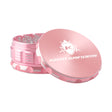 Kozo 4 inch four-piece anodized aluminum grinder in rose gold, lid tilted open beside the toothed grinding chamber