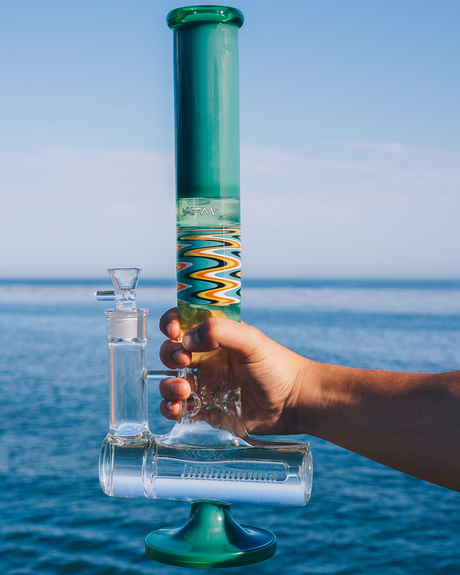 17" AFM Glass Beaker Bong with Reversal Inline Perc, Colored Glass, held over water backdrop