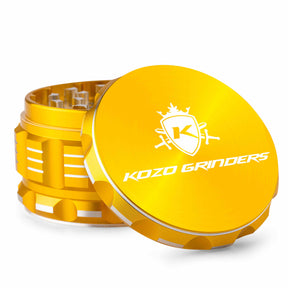 Kozo 3 inch aircraft-grade aluminum grinder in gold, angled view with the lid tilted open and logo visible