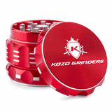 Kozo 2 inch aircraft-grade aluminum grinder in red, angled view with the lid tilted open and logo visible