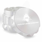 Kozo 2 inch aircraft-grade aluminum grinder in silver, angled view with the lid tilted open and logo visible