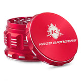 Kozo 2.5 inch aircraft-grade aluminum grinder in red, angled view with the lid tilted open and logo visible