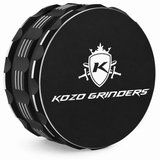 Kozo 3.5 inch ceramic non-stick aluminum grinder in black, angled view showing the grip notches and the Kozo logo lid