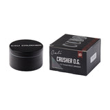 Cali Crusher O.G. 2.5" Aluminum 4-Part Grinder next to its packaging box