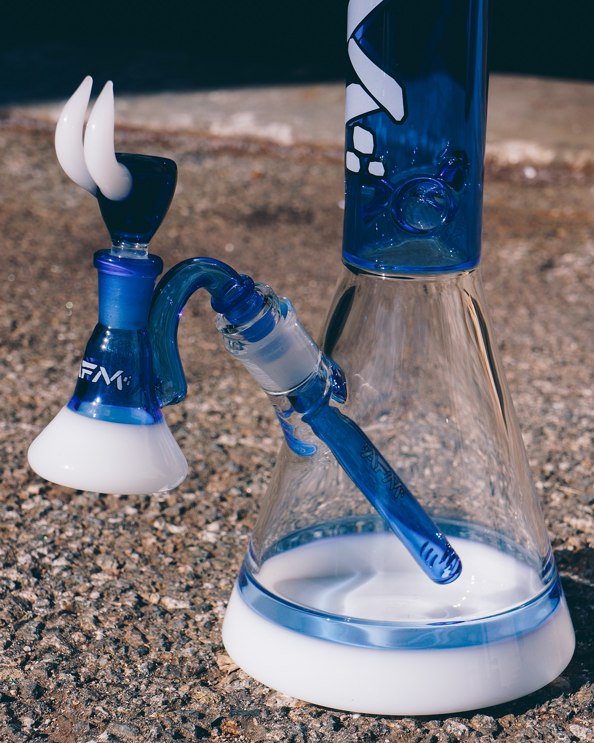 AFM Quasar Ink Blue Glass Beaker Bong, 18-inch, 14mm Female Joint, Side View on Concrete