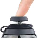 Close-up of Puffco Proxy Carb Cap in black with a finger pressing down, showing ease of use