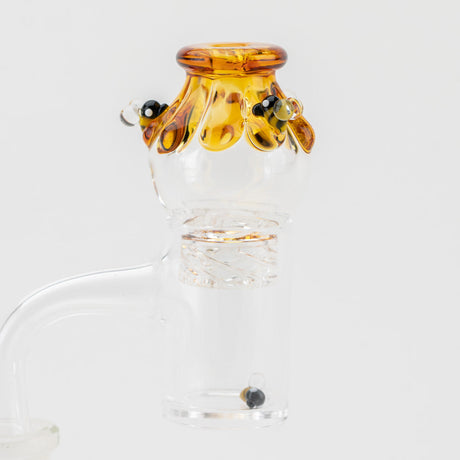 Empire Glassworks Beehive Spinner Cap in amber hues, side view on clear glass dab rig