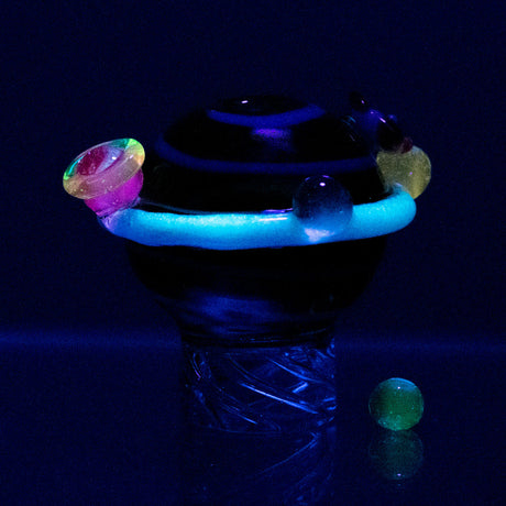 Empire Glassworks Galactic Spinner Cap with glow effect, front view on dark background