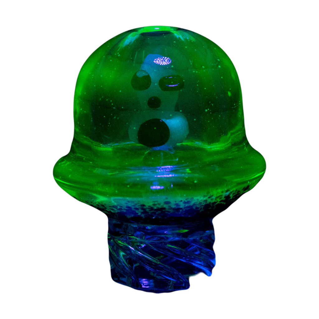Empire Glassworks UV Illuminati Martian Spinner Cap glowing under UV light, front view