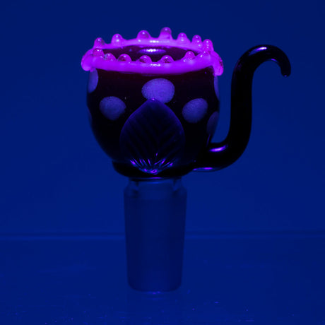 Empire Glassworks Fire Plant Bowl Piece glowing under UV light, front view on blue background
