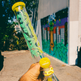 AFM Phoenix 9mm Clear Glass Beaker Bong held in hand with street art background