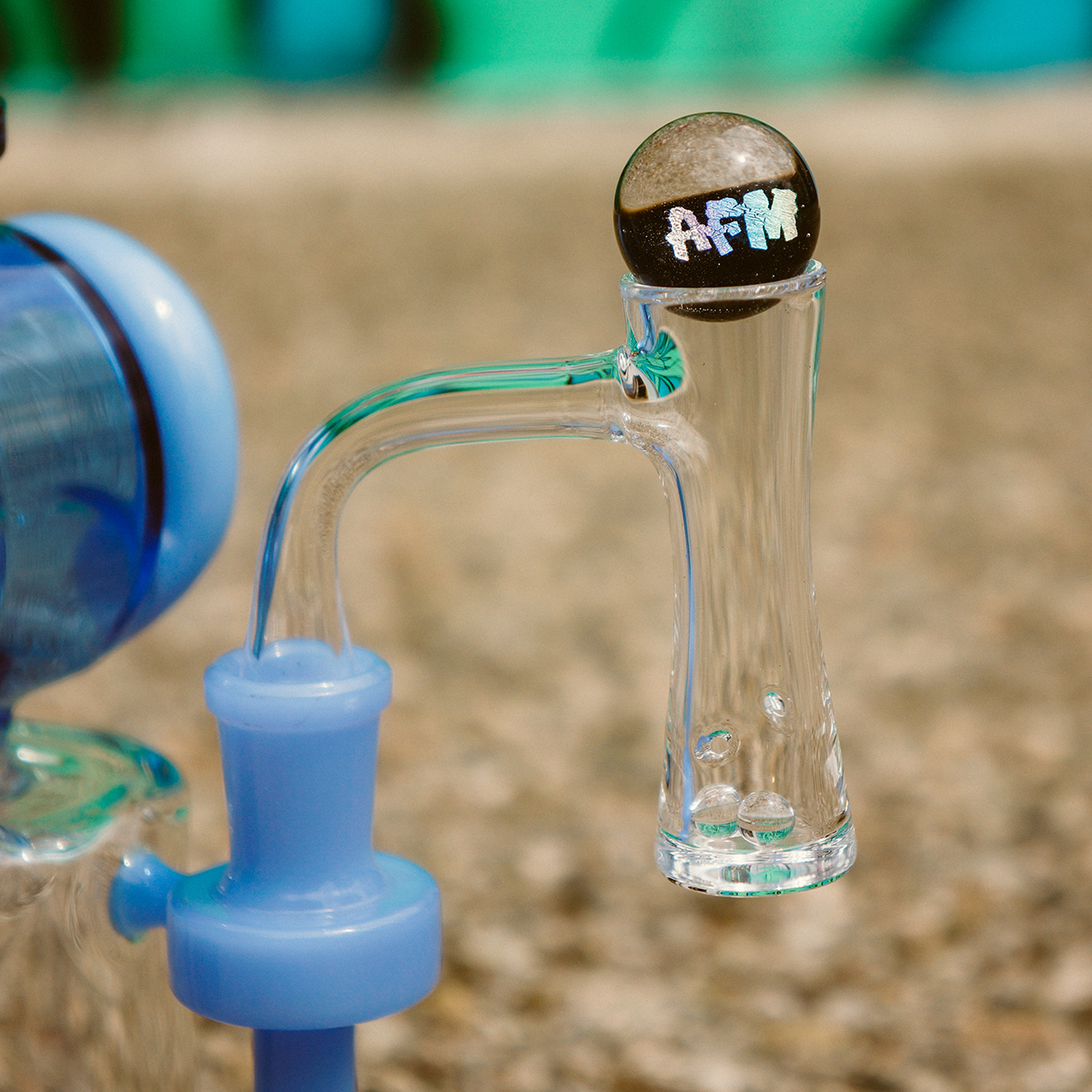 AFM Whirlpool Quartz Dab Banger Set attached to blue rig, clear side view