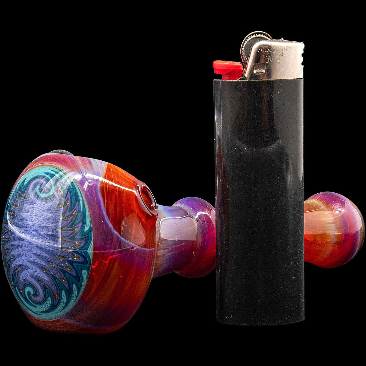 Lezak Glass Reversal and Opal Marble Glass Spoon Pipe with intricate design, side view next to lighter