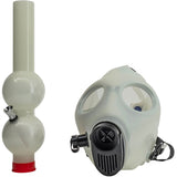JM Enterprises acrylic gas mask bong shown disassembled, diffuser tube beside the mask, unlit acrylic