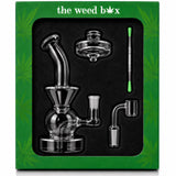 The Weed Box Ultimate Dabber Kit laid out in branded green packaging with rig, banger, cap, and dabber tool