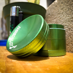 Sir Shredalot 4-Part Grinder 40mm with Carved Lid in Green, Angled View on Wooden Surface