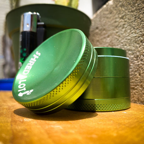 Sir Shredalot 4-Part Grinder 40mm with Carved Lid in Green, Angled View on Wooden Surface