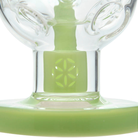 Close-up of Calibear Fab Egg Seed Of Life Dab Rig with green color accents and borosilicate glass