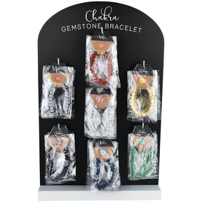 Display of 35 Chakra Gemstone Bracelets in various colors on a black stand, front view