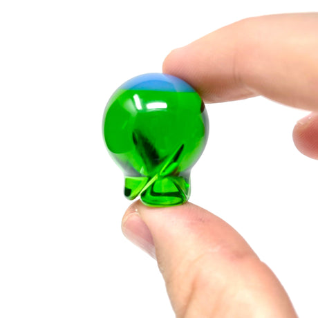 AFM Spinner Ball in green held in hand, close-up view, essential bong accessory