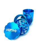 AFM 5-Piece Aluminum Herb Grinder in blue with textured grip and fine mesh screen, angled view