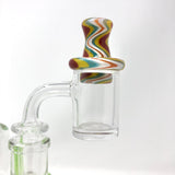 AFM Reversal Spinner Cap with colorful swirl design and two glass pearls, side view on clear banger