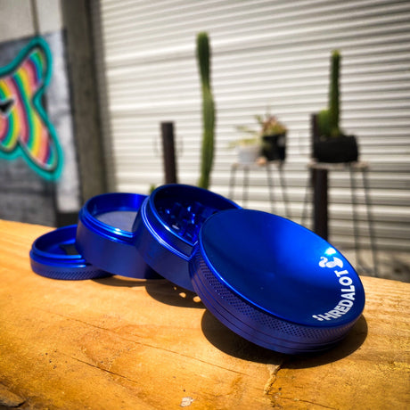 Sir Shredalot 4-part Grinder 63mm in blue with caved lid, open on wooden surface