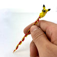 AFM Pikachu Glass Dabber Tool with red and yellow spiral design held in hand - DankGeek