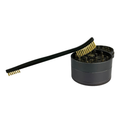 Snowtree Grinder Brush resting on open black grinder, side view, for easy cleaning