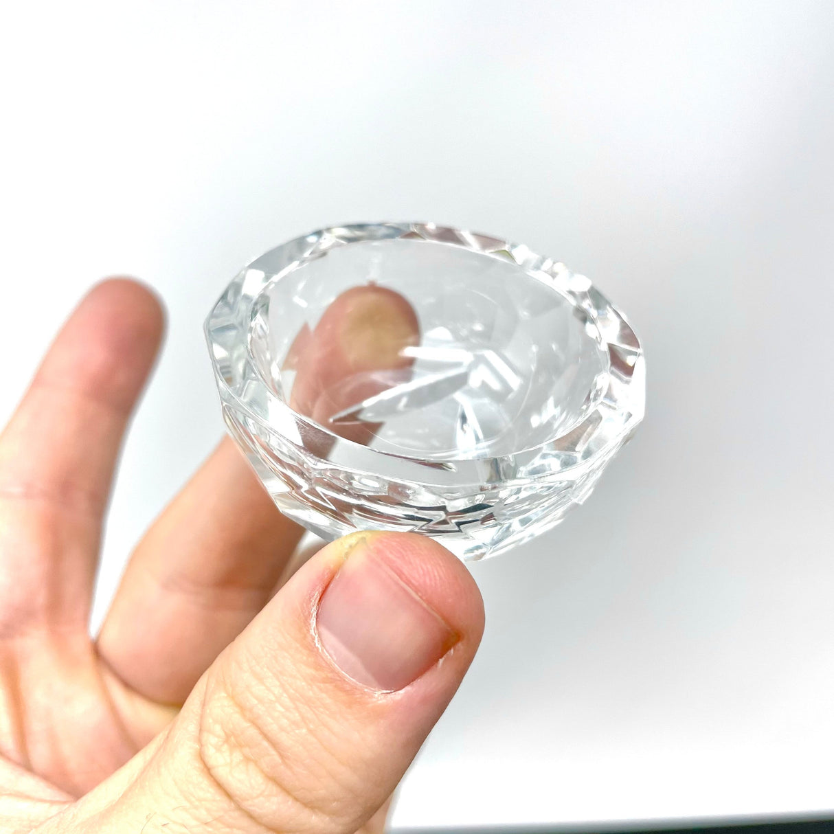 AFM Disc Spinner Carb Cap Dish V3 held in hand, showcasing its clear borosilicate design