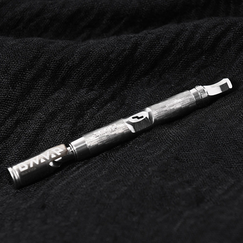 DynaVap The M 7 XL vaporizer resting on a textured fabric background, showing the full stainless steel body.
