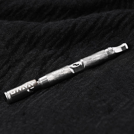 DynaVap The M 7 XL vaporizer resting on a textured fabric background, showing the full stainless steel body.