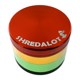 Sir Shredalot 4-Piece Metal Herb Grinder in vibrant rasta colors, top view showing logo