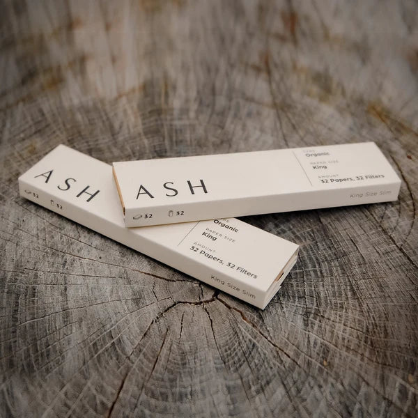 ASH Organic King Size Slim Rolling Papers on wooden background, 3 packs with 32 leaves each