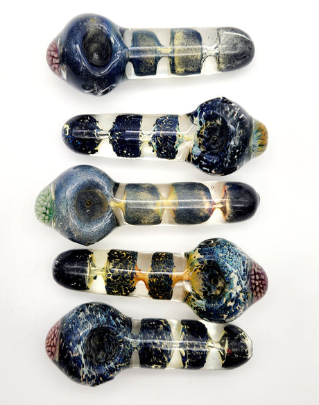 Assortment of Fritted Glass Spoon Pipes in various designs, top view on white background