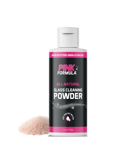 Pink Powder 4oz bottle of all-natural glass cleaner by Pink Formula, front view with a pile of pink salt