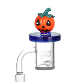 Halloween-themed Air Spin Channel Carb Cap with pumpkin design on a glass dab rig