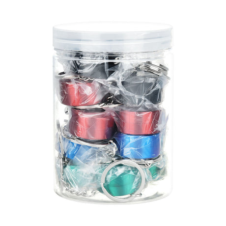 Transparent jar filled with 20 assorted colored Grav keychain grinders, compact and portable