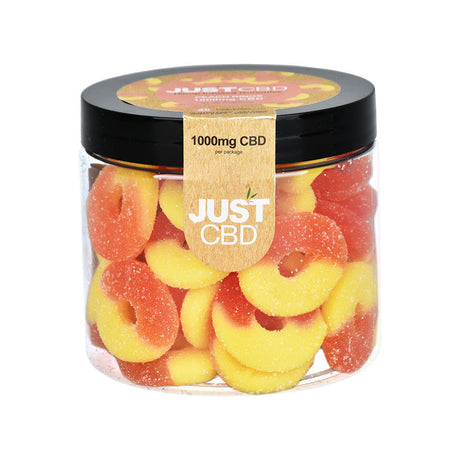 Front view of JUST CBD Gummies in a clear jar, 1000mg CBD, colorful peach rings visible