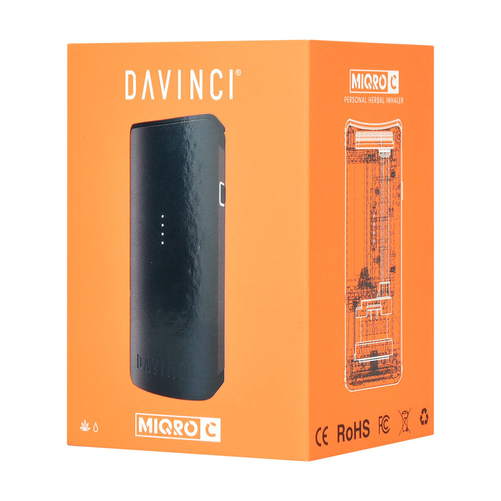 DaVinci Miqro-C Dry Herb Vaporizer in black with 900mAh battery, front view on orange packaging