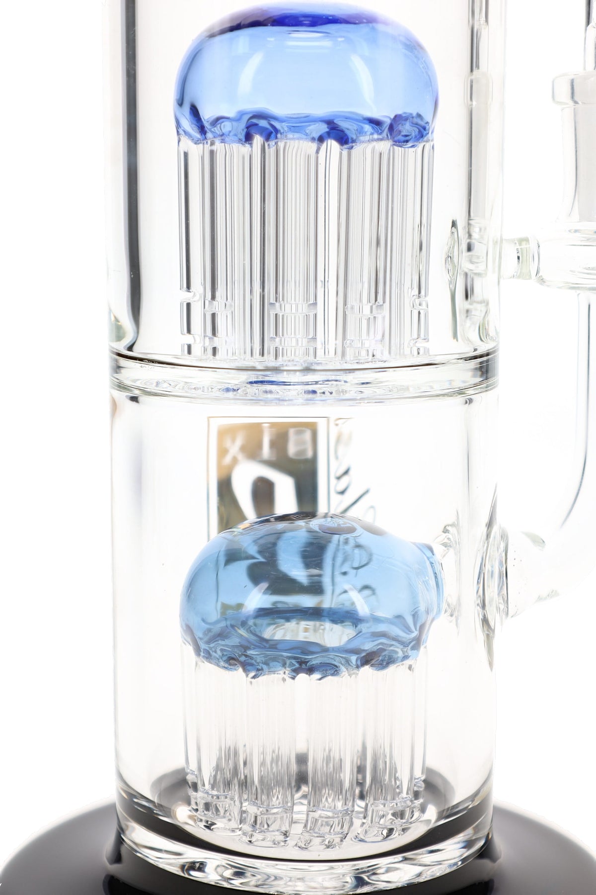 Close view of two stacked tree percolators with blue dome tops inside the 6B Glass double tree bong