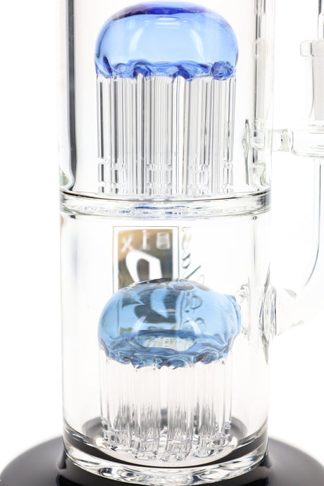 Close view of two stacked tree percolators with blue dome tops inside the 6B Glass double tree bong