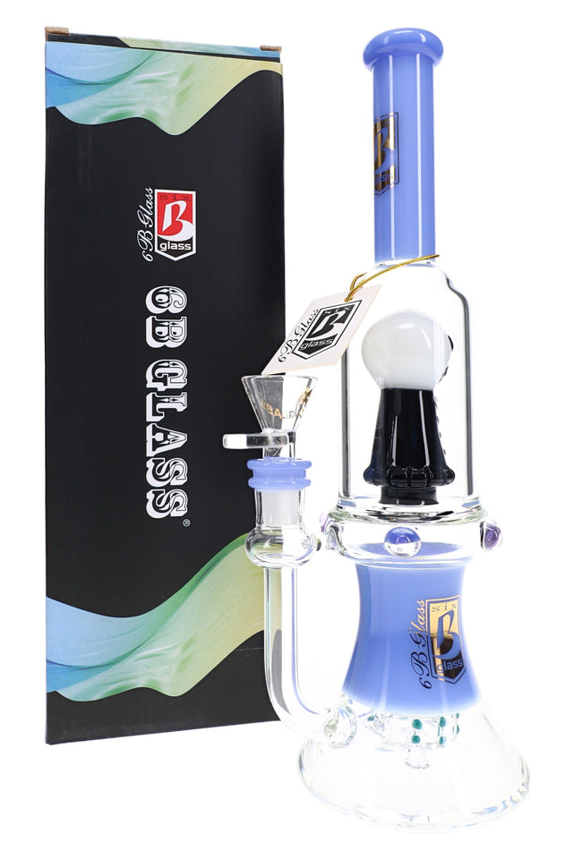 6B Glass 11.5 inch skull showerhead perc bong with a periwinkle neck and base, shown next to its retail box