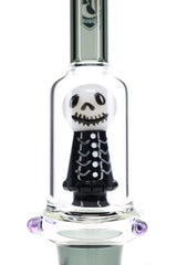 Close view of the white and black sculpted skull percolator inside the clear chamber of the 6B Glass bong