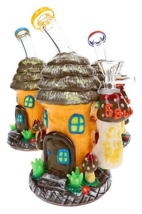 Three 6B Glass mushroom hut bongs with layered roofs, wooden doors, windows, and garden details on the base