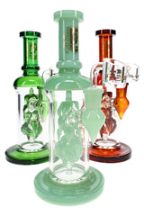 Three 6B Glass vine leaf perc dab rigs in green, mint, and amber with leaf percolators and matching bases