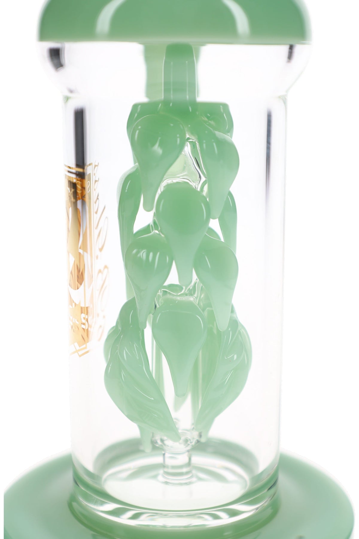 Close view of the sculpted vine leaf percolator in mint green glass inside the clear chamber of the dab rig
