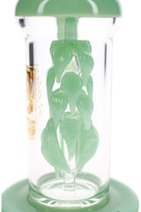 Close view of the sculpted vine leaf percolator in mint green glass inside the clear chamber of the dab rig