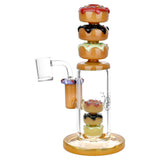 Pulsar Donuts Upon Donuts Rig with colorful doughnut stack design, 14mm female joint, front view on white background