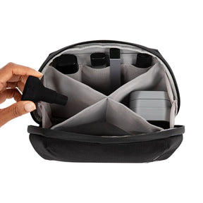 Open PAX Smell Proof Bag - Medium showing compartments with a hand inserting an item